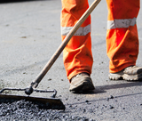 A person in safety clothing conducting road works